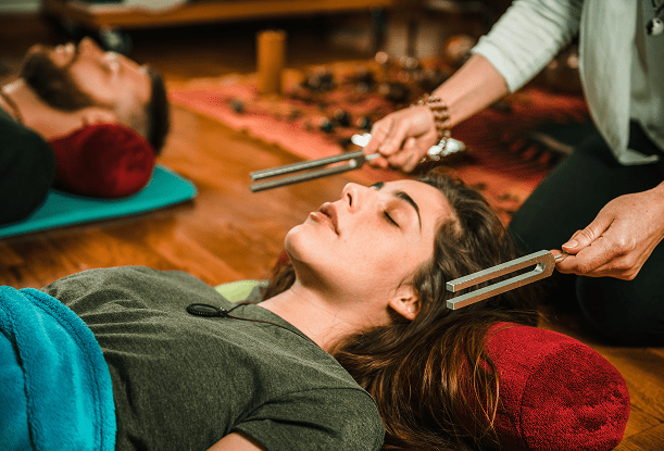 Sound therapy session with tuning forks.